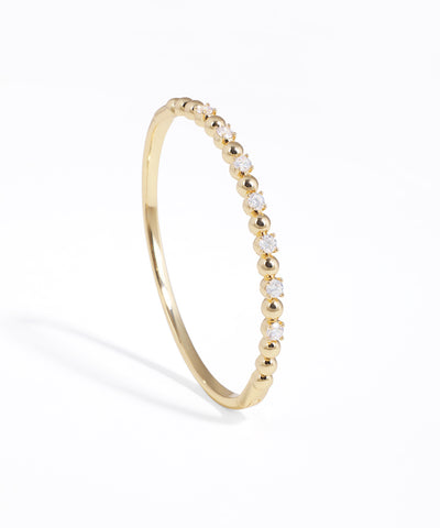 Gold-tone bracelet with alternating cubic zirconia stones and beads