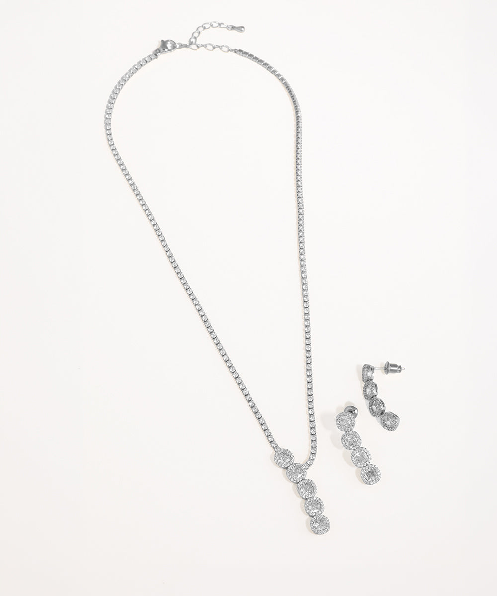 Silver necklace and earrings set on a white background