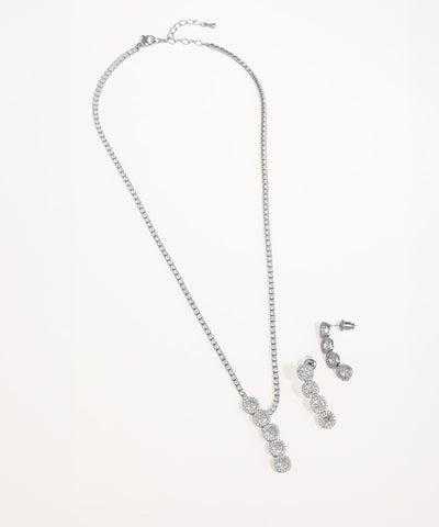 Silver necklace and earrings set on a white background