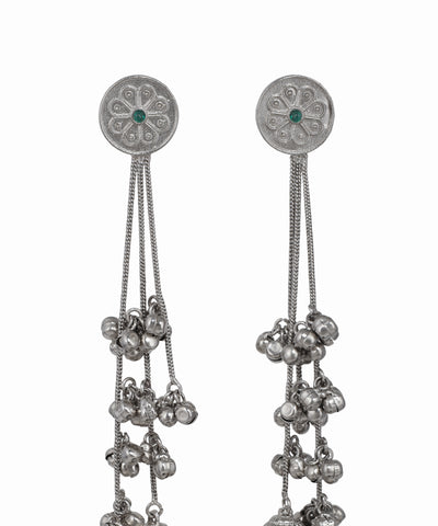 Pair of silver earrings with chain and bead details on a white background