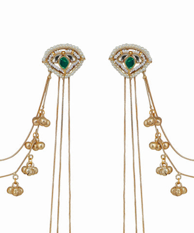 Gold earrings with green gemstones and dangling beads on a white background