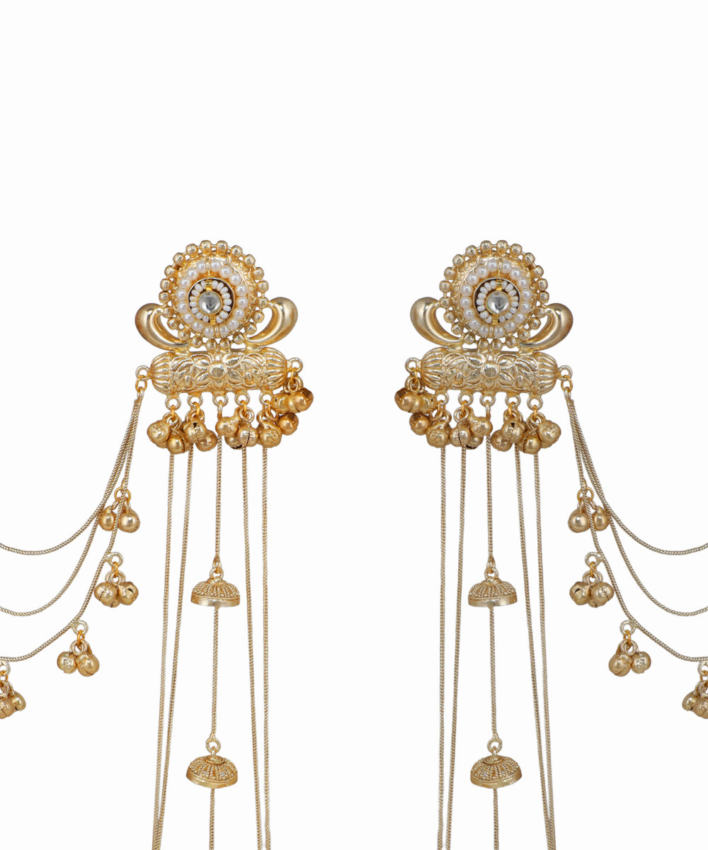 Gold hair accessories with intricate designs on a white background