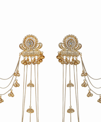 Gold hair accessories with intricate designs on a white background