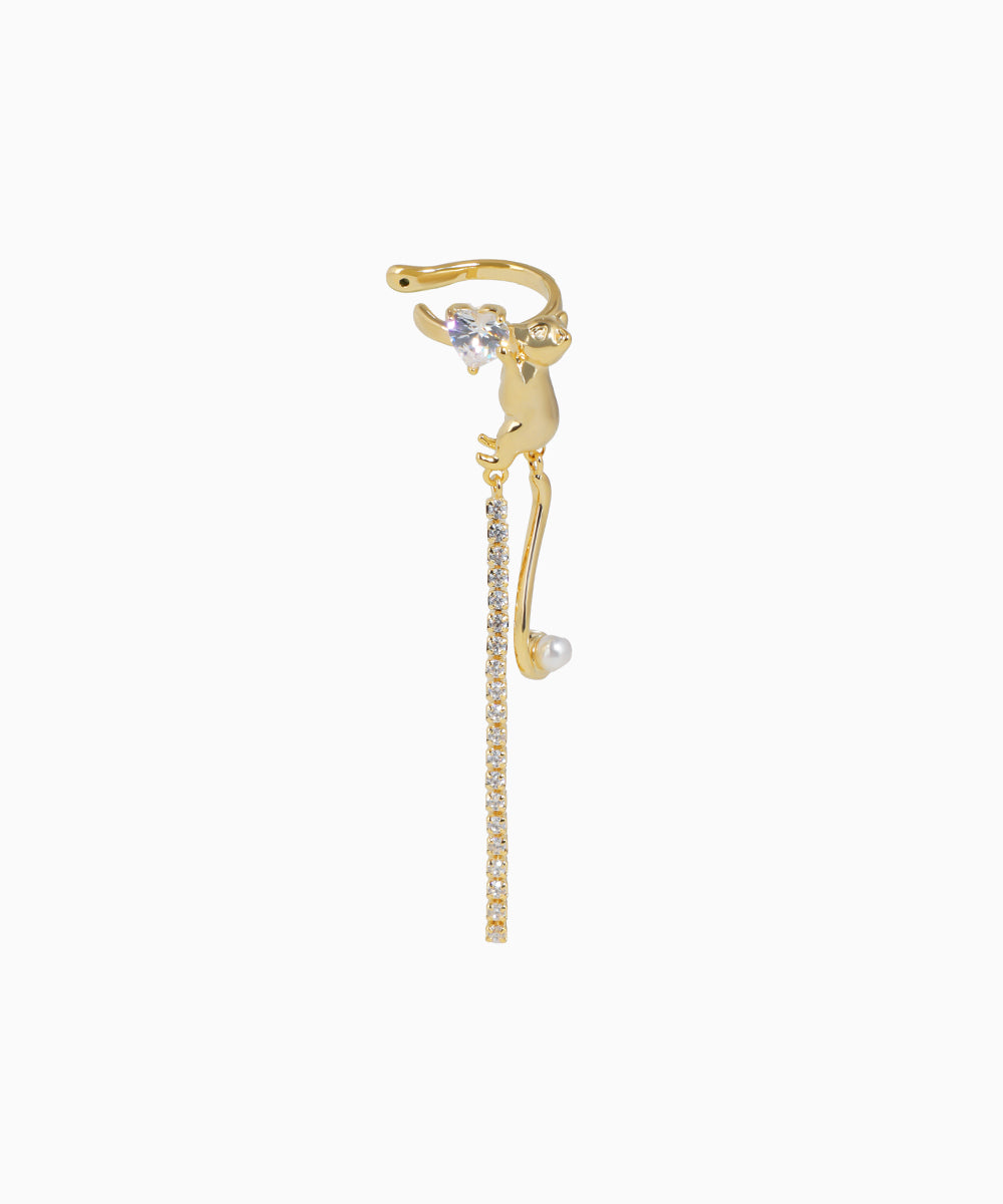 Gold cat-shaped earring with a small pearl on a white background