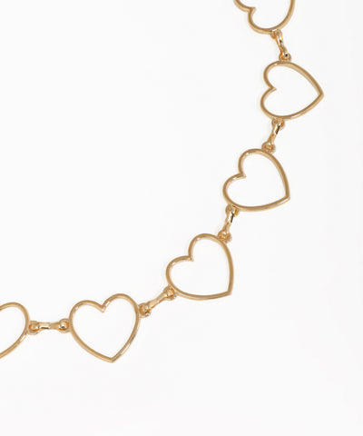 Gold heart-shaped necklace on a white background