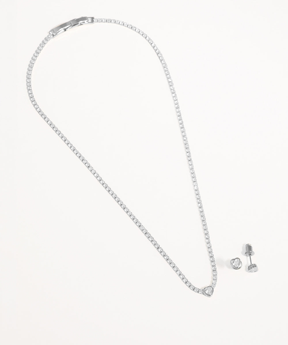 Silver necklace and earrings on a white background