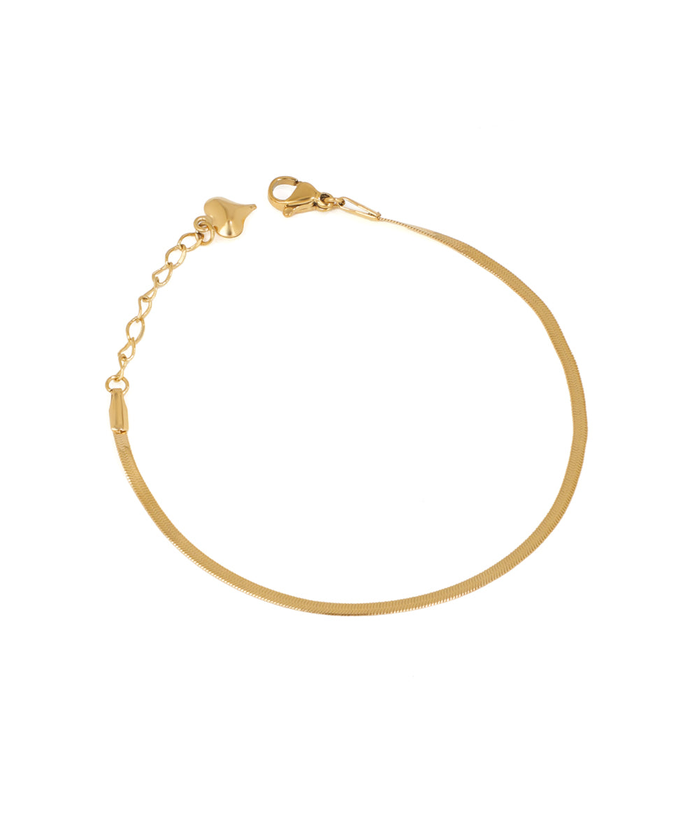 Gold-tone herringbone chain bracelet with a lobster clasp and heart charm extender