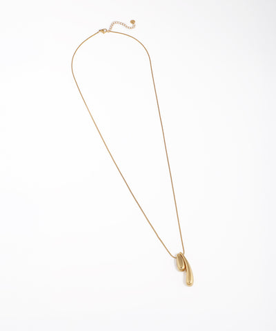 Gold-tone necklace with an abstract, polished sculptural pendant
