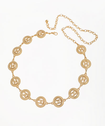 Gold-tone waist chains with circular interlocking C medallions and an adjustable clasp.