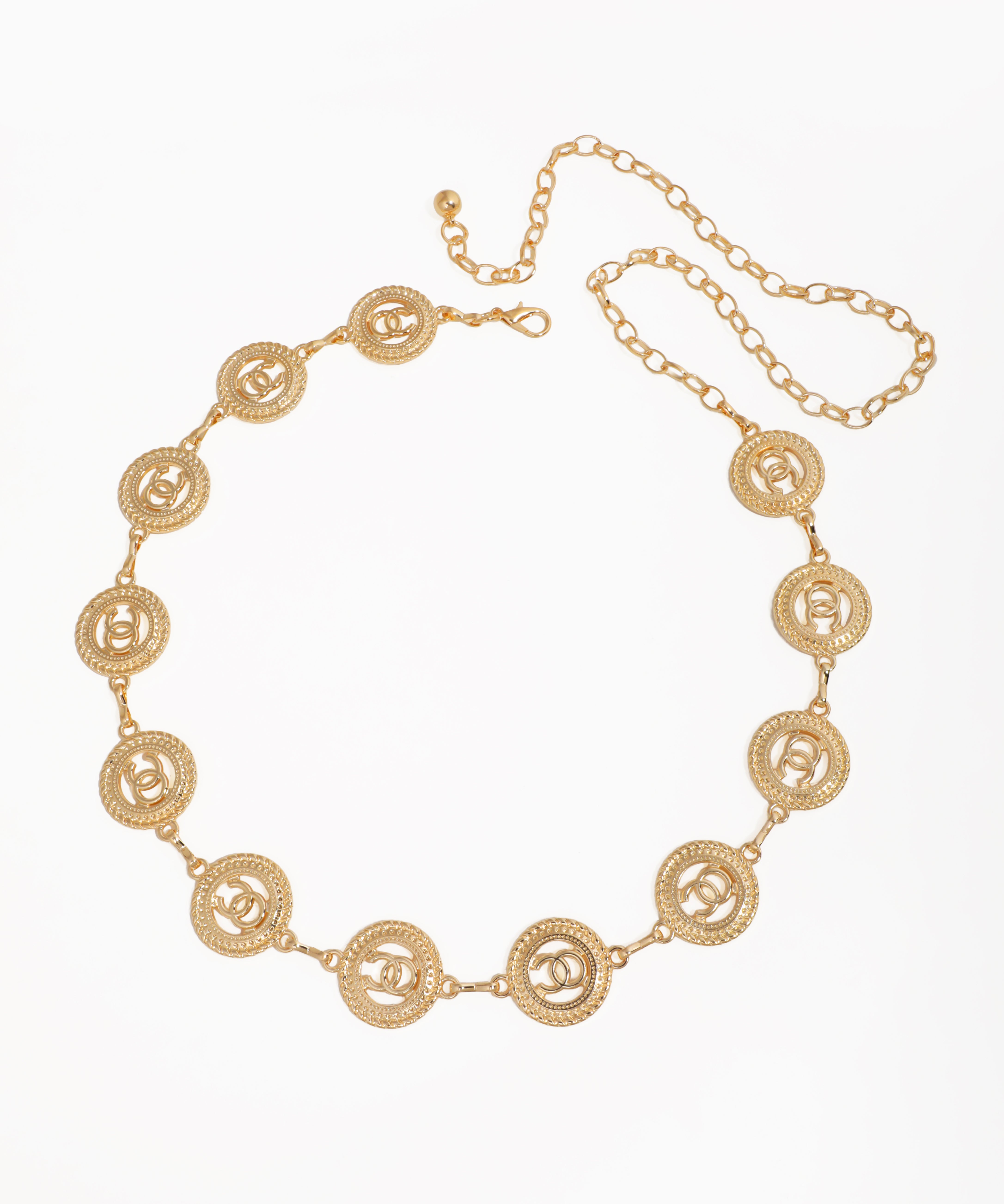 Gold-tone waist chains with circular interlocking C medallions and an adjustable clasp.