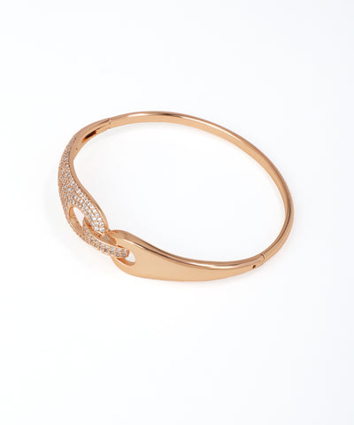 Rose gold bracelet with intricate design on a white background