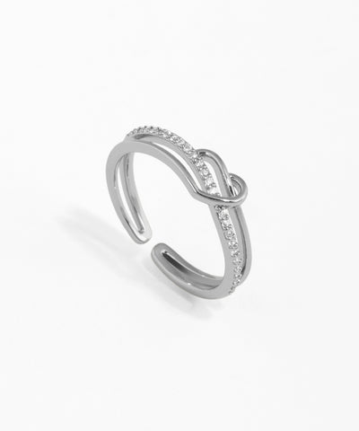 Silver ring with small diamonds on a white background