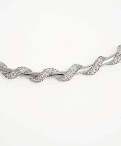 Silver bracelet with a twisted design on a white background