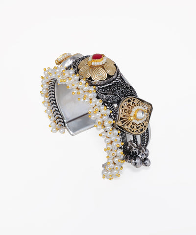 Decorative bracelet with intricate design on a white background