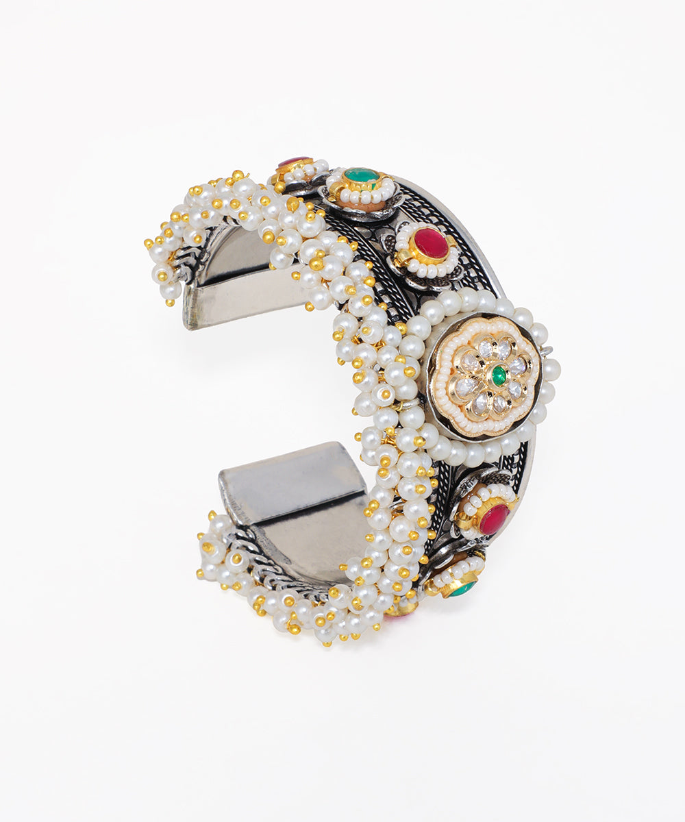 Oxidise silver-tone cuff bracelet with clusters of faux pearls, central floral motif, and colourful glass crystals.