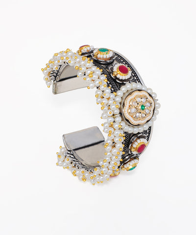 Oxidise silver-tone cuff bracelet with clusters of faux pearls, central floral motif, and colourful glass crystals.