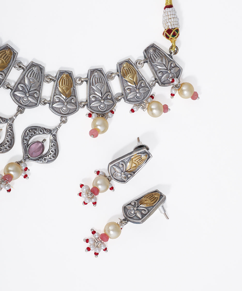 Decorative necklace with pendants and pearls on a white background
