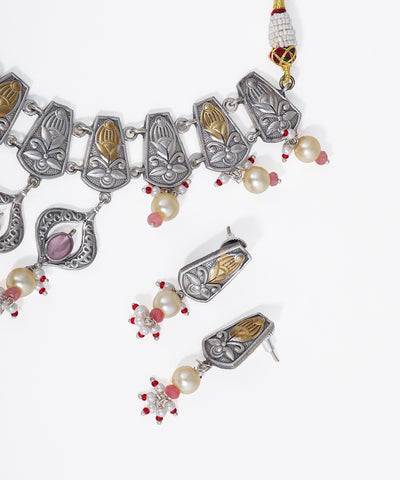 Decorative necklace with pendants and pearls on a white background