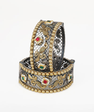 Decorative bracelet with gold and silver design on a white background