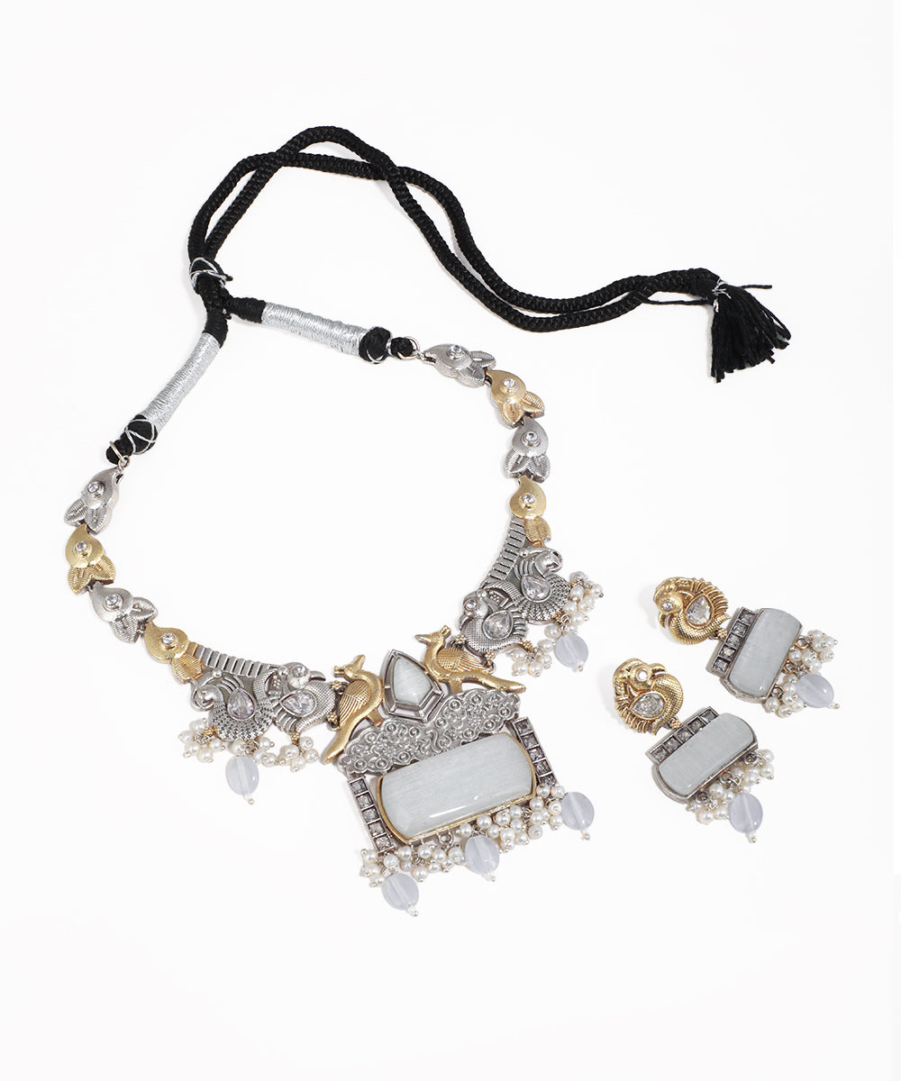 Ornate necklace with matching earrings on a white background