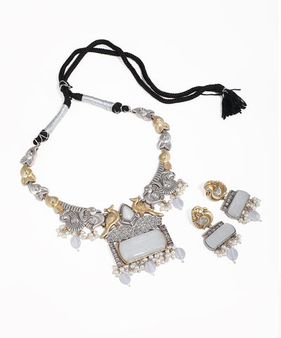 Ornate necklace with matching earrings on a white background