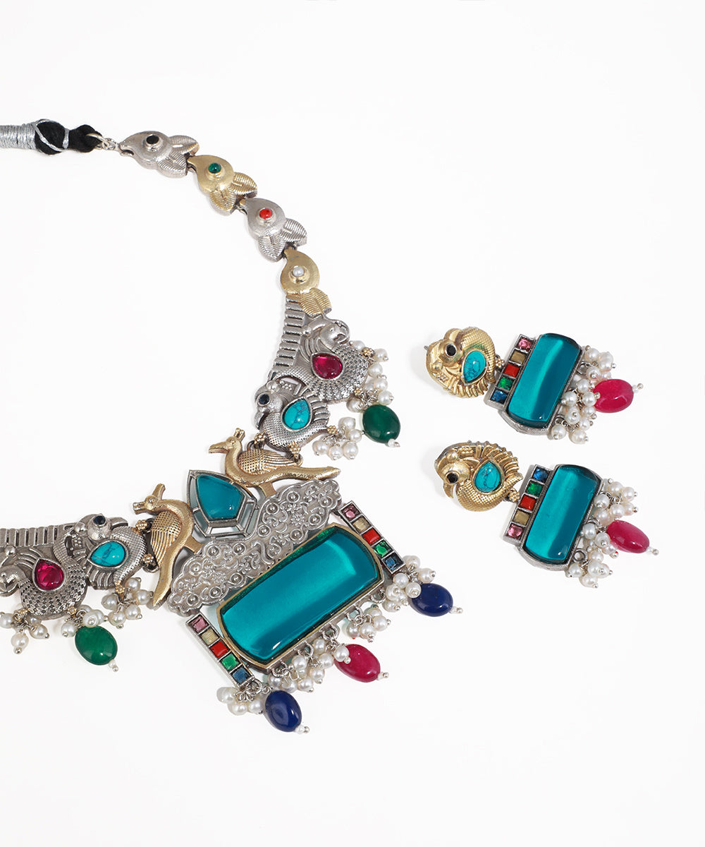 Ornate necklace with colorful gemstones on a white background