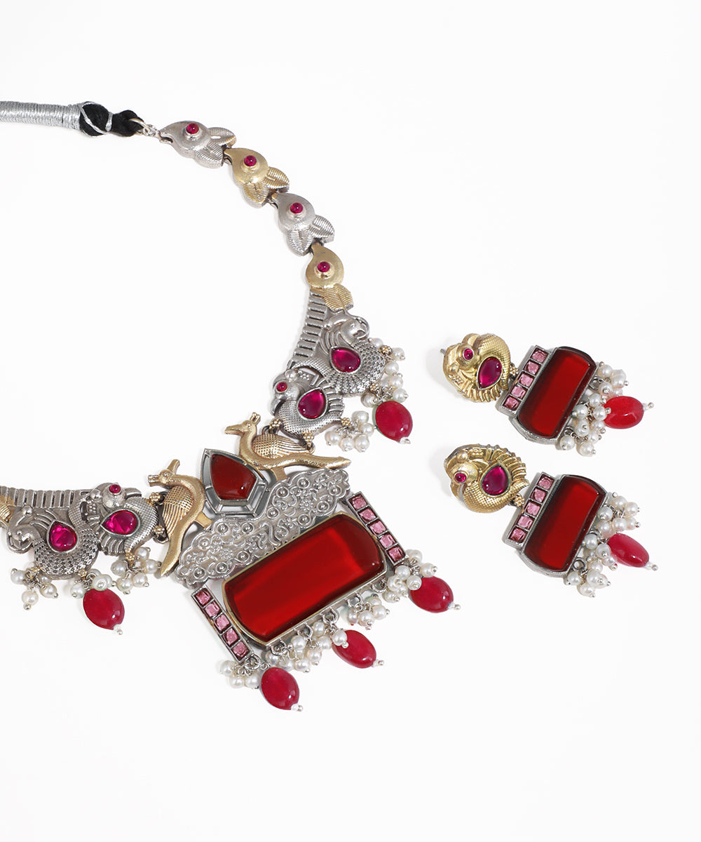 Ornate necklace with red stones on a white background