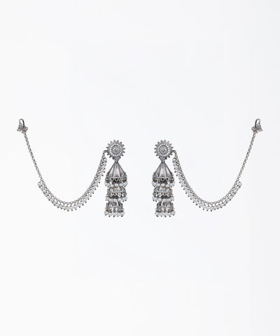 Oxidized silver-tone tiered jhumka earrings with faux pearls, CZ stones, and attached pearl ear chains.