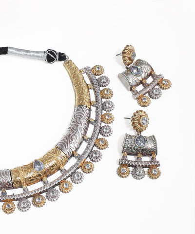 Ornate necklace and earrings on a white background