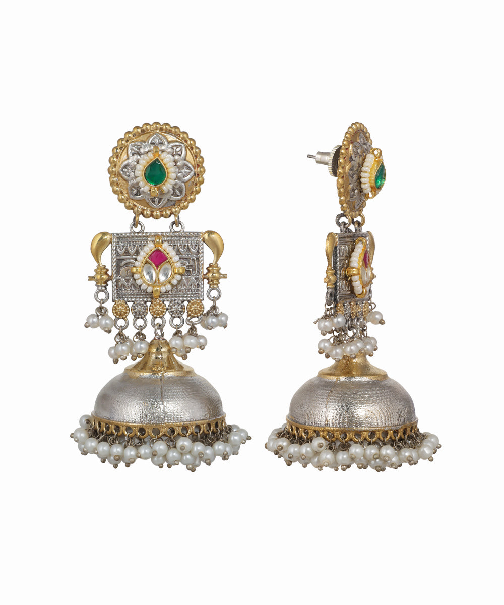 Ornate earrings with gold, silver, and gemstone details on a white background