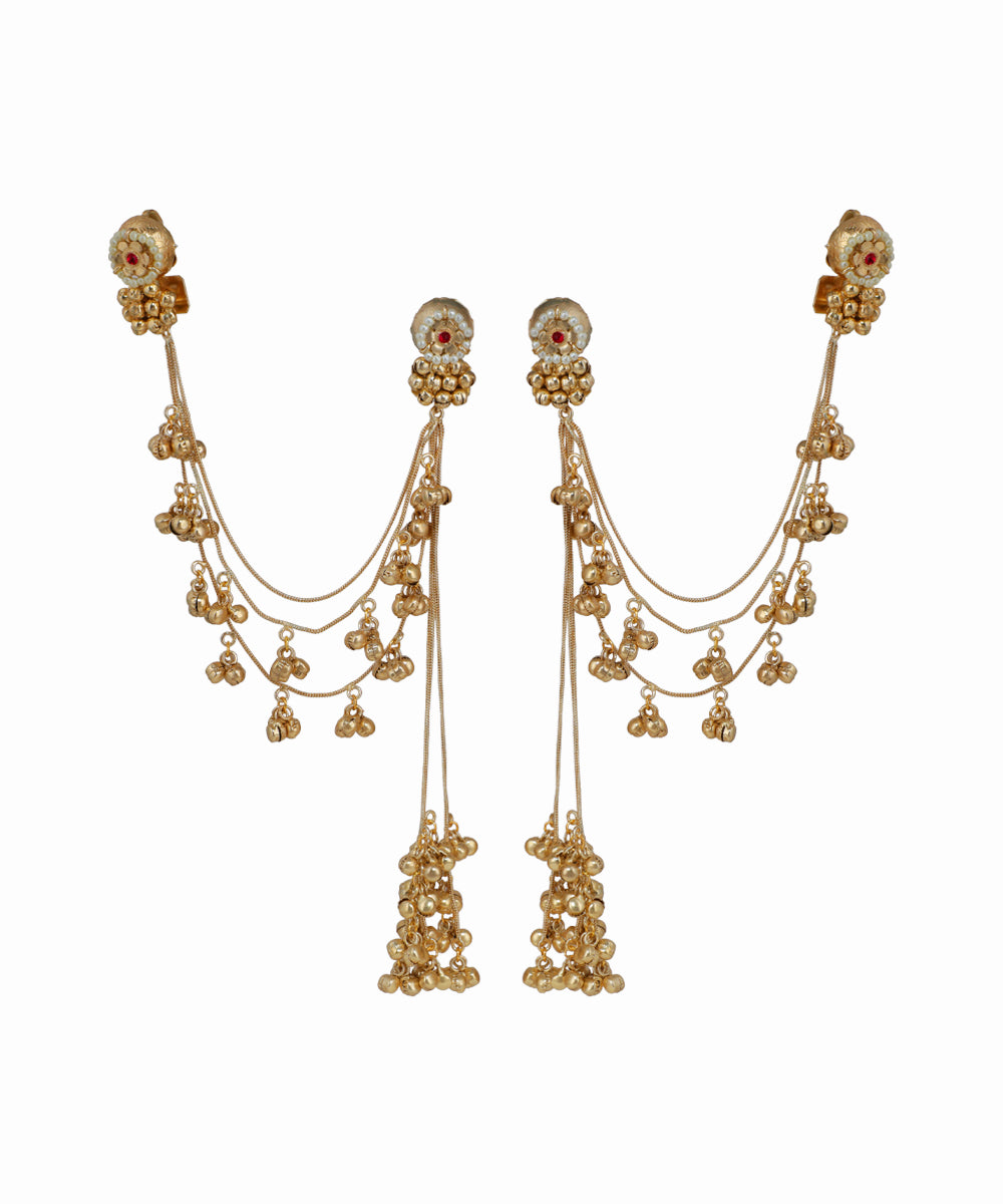 Gold earrings with dangling beads on a white background