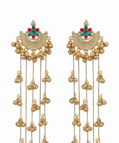 Pair of gold earrings with green and red gemstones on a white background