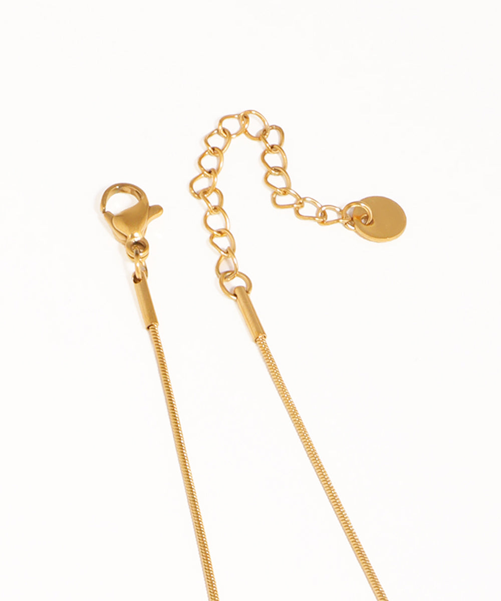 Gold chain necklace on a white background