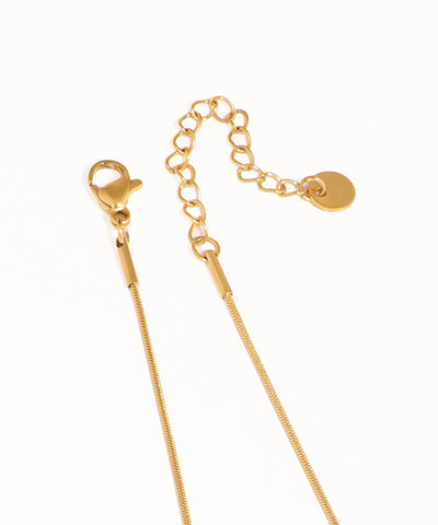 Gold chain necklace on a white background