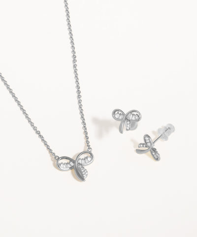 Silver bow-shaped necklace and earrings on a white background