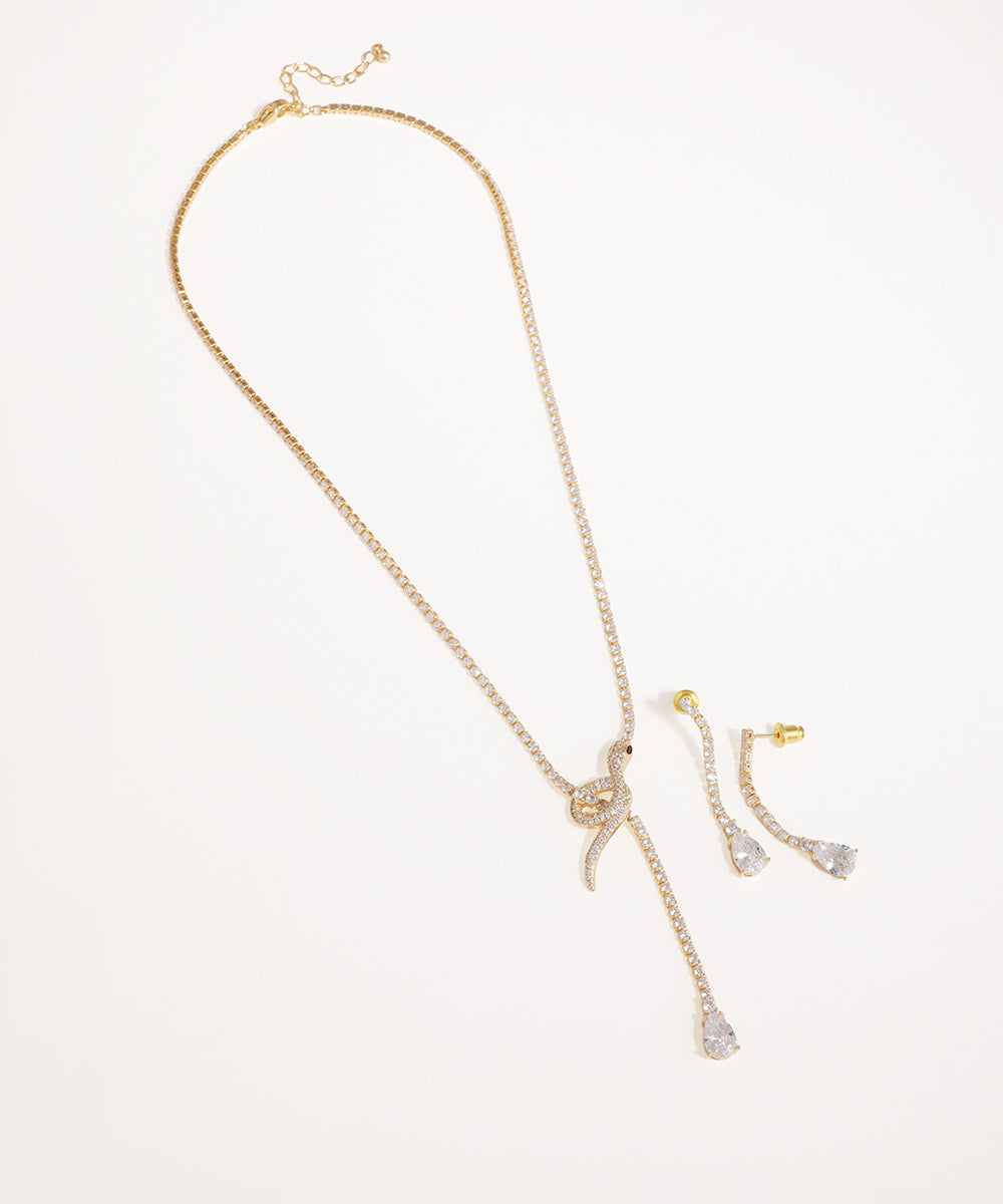 Gold-tone necklace with CZ stones in a knot and drop design, with matching earrings