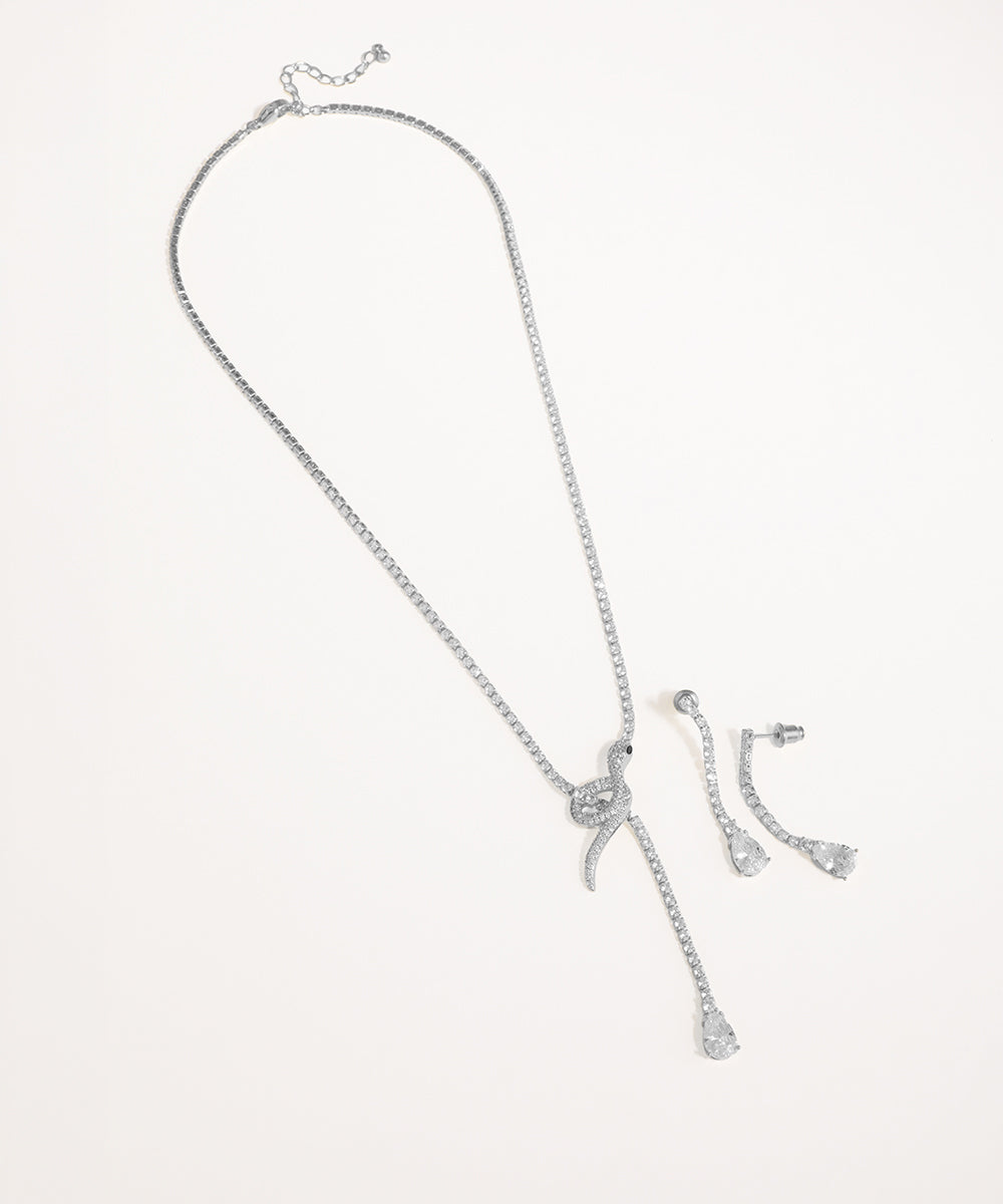 Silver necklace and earrings set on a light gray background