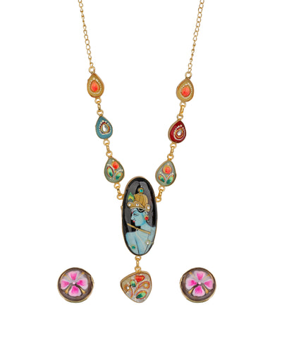 Gold-tone necklace with colorful enamel details and a central oval pendant depicting a blue-skinned figure, shown with matching stud earrings on a white background.
