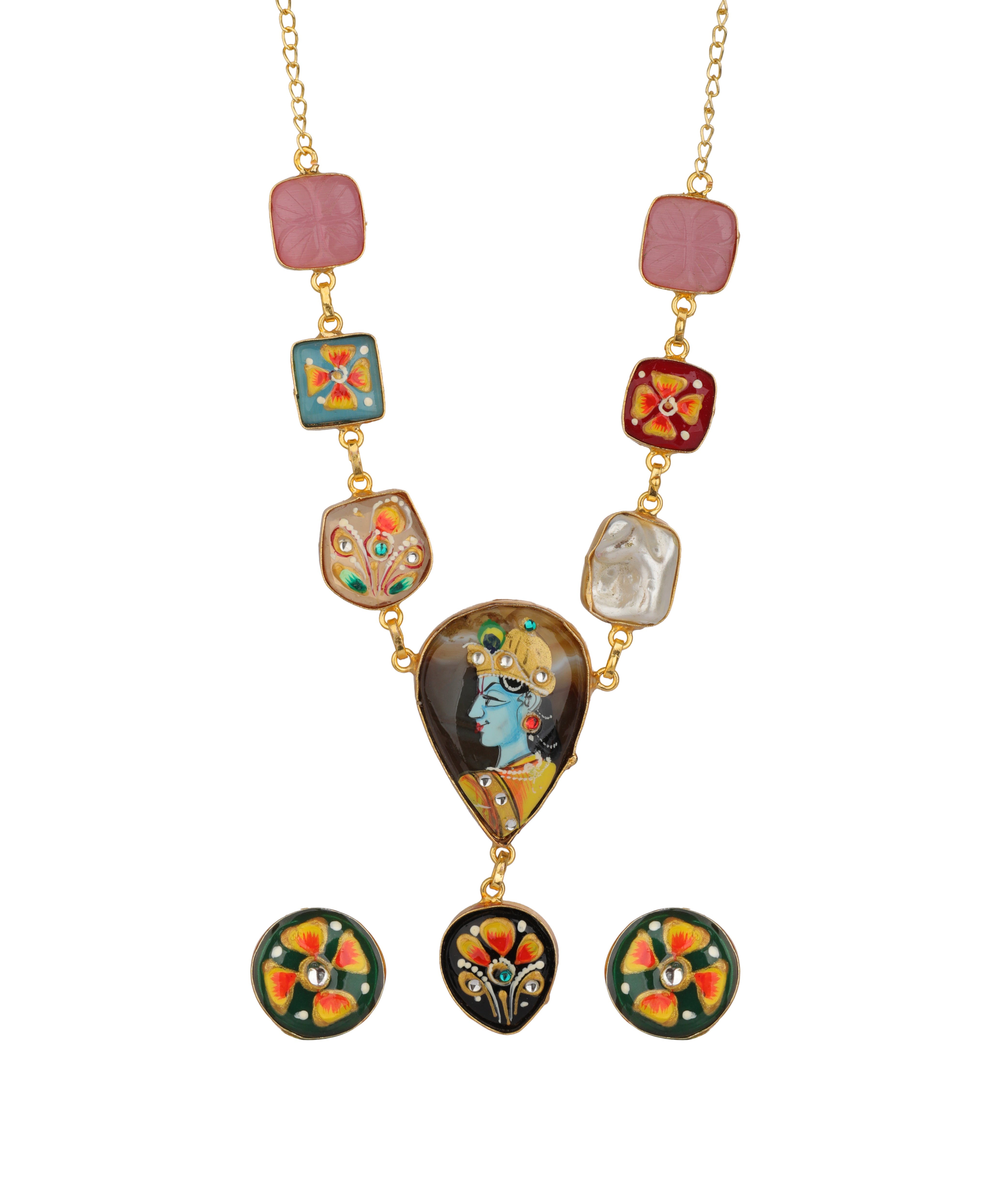 A gold-tone necklace with a large central teardrop pendant featuring a hand-painted illustration of Lord Krishna, flanked by smaller decorative beads and matching circular earrings, shown on a plain white background.