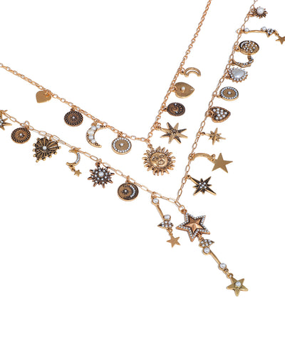 Gold necklace with star, moon, and sun charms on a white background