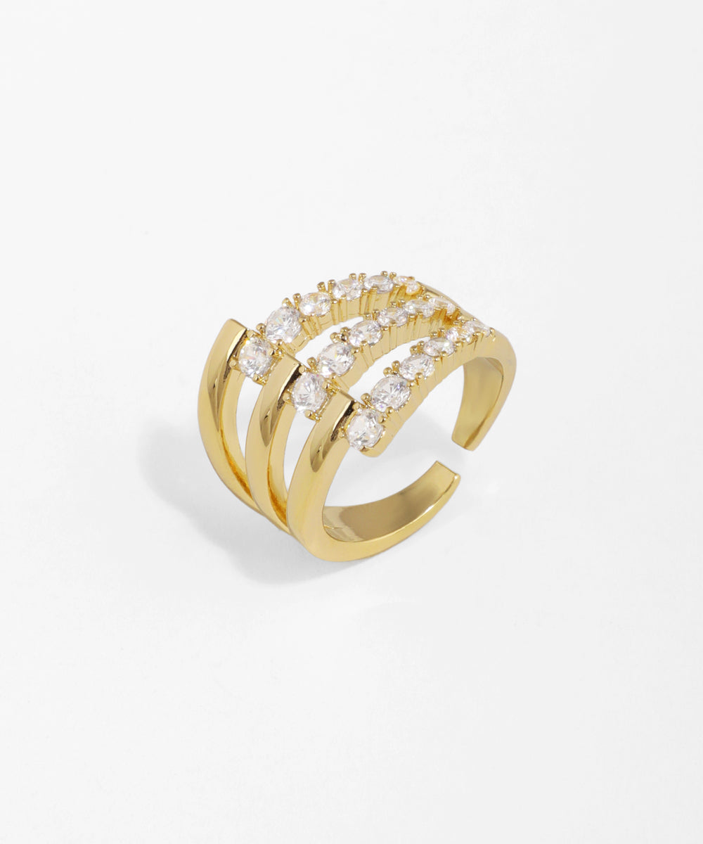 Gold-tone ring with multiple bands and rows of clear cubic zirconia stones in an open design.