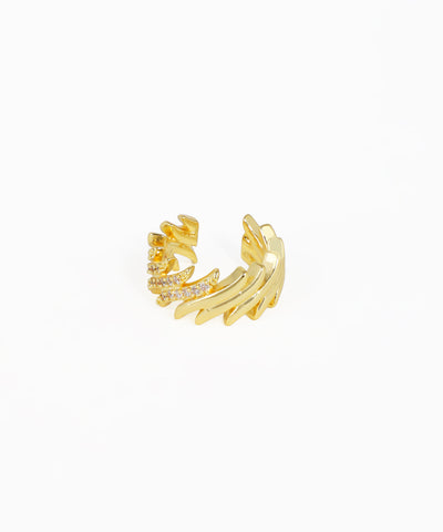 Gold ear cuff with intricate design on a white background