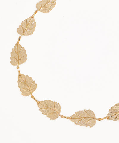Gold leaf necklace on a white background