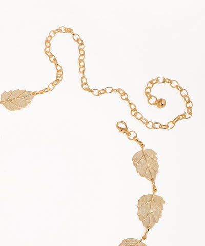 Gold chain necklace with leaf pendants on a white background