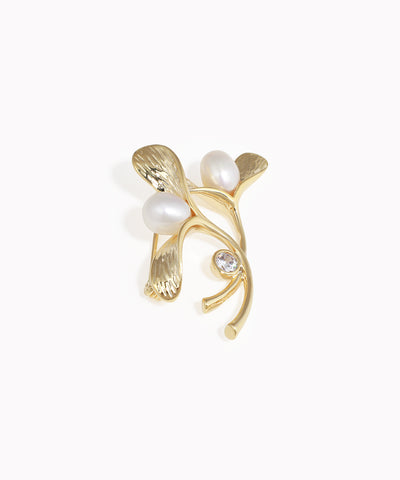 Gold-tone brooch with organic leaf design, faux pearls, and clear CZ stone