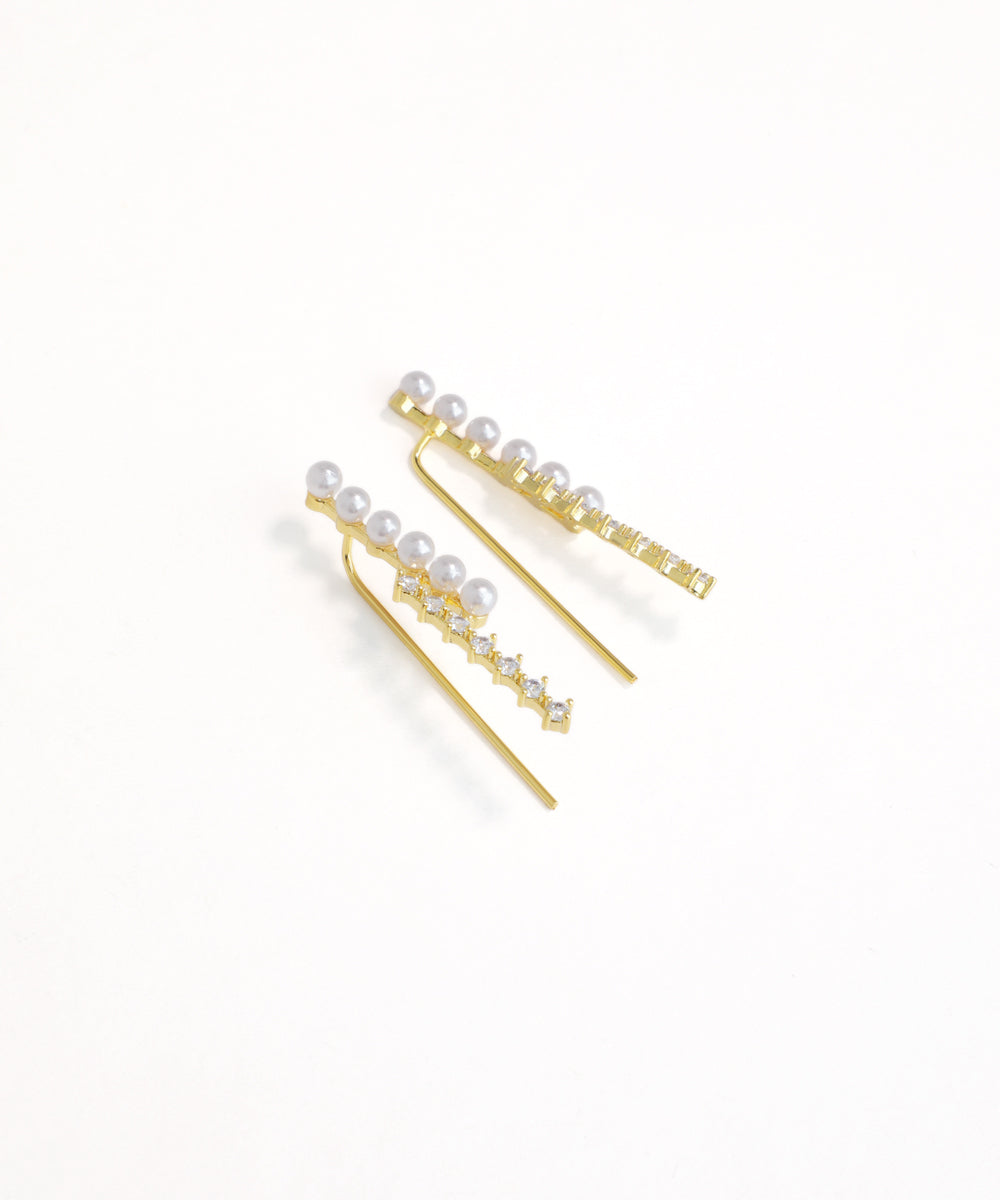 Gold hair pins with pearls on a white background