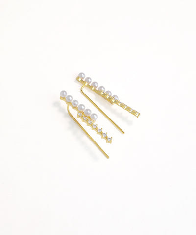 Gold hair pins with pearls on a white background