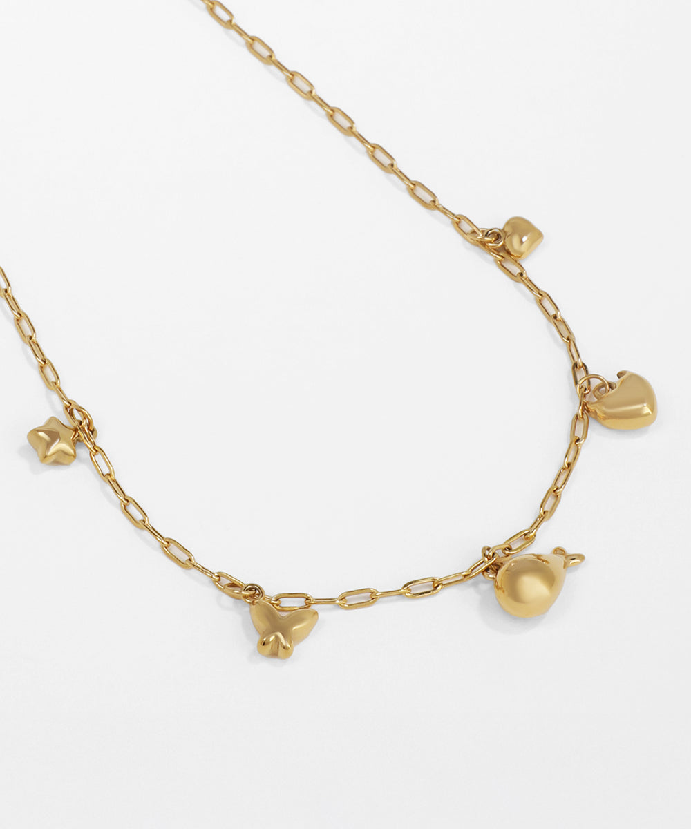 Gold necklace with heart-shaped pendants on a white background