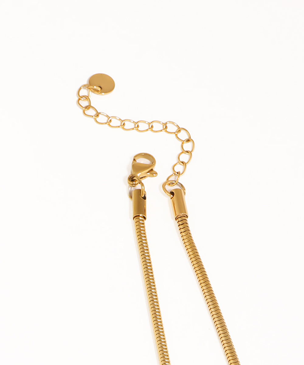 Gold chain necklace on a white background