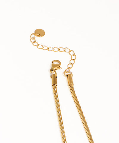 Gold chain necklace on a white background